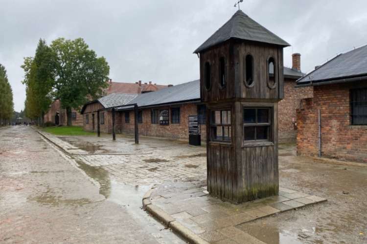 Roll call square with gallows in the background at Auschwitz