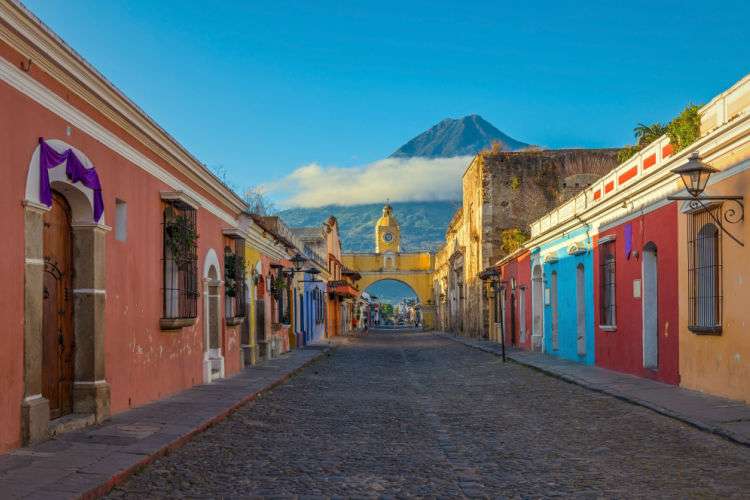 The main street in Antigua in Guatemala overlooked by Agua Volcano