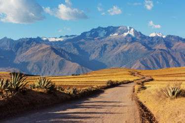 Dirt road in Peru with Andes in the background