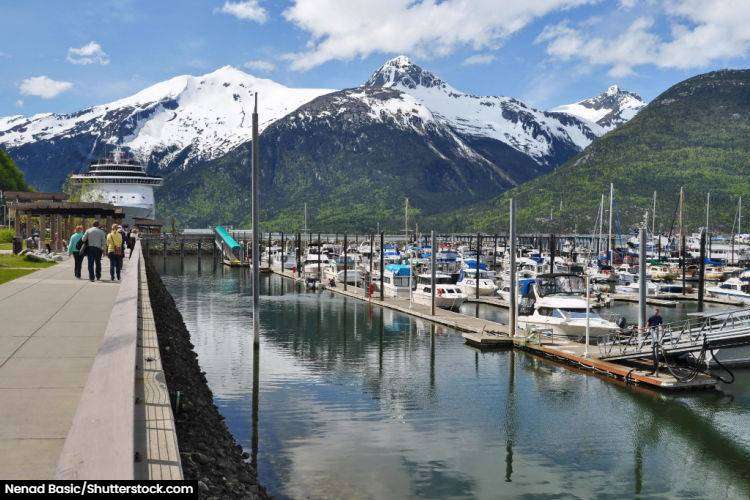 The harbourside at Skagway with yacht and a large cruiseship in the background